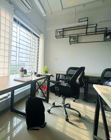 An office featuring a desk, a chair, and a window
